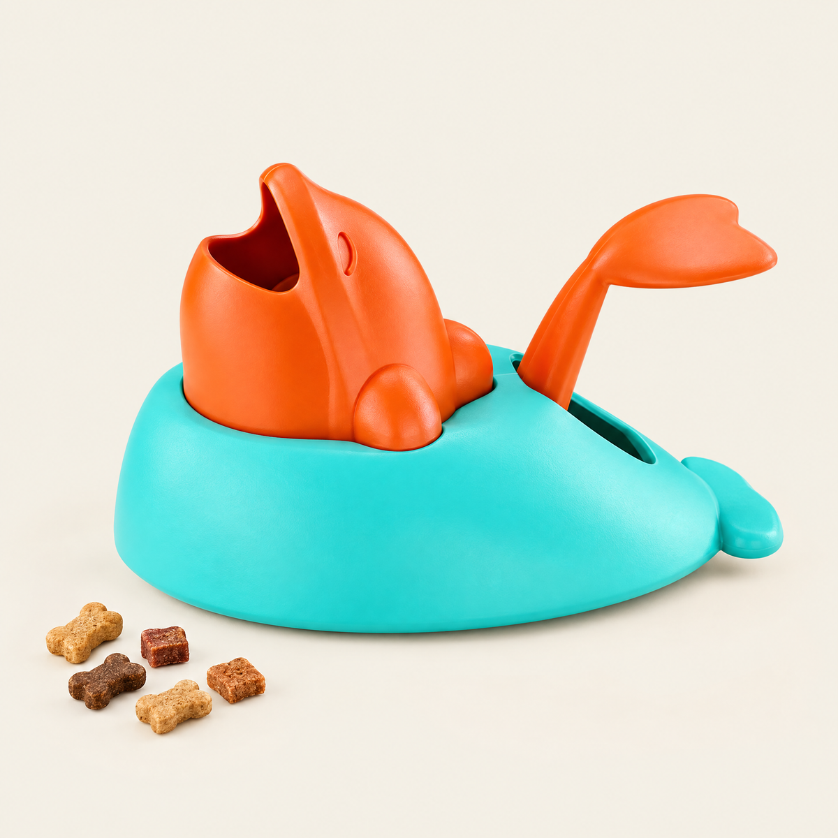 Lanceur de friandises en forme de baleine turquoise et orange, sur fond crème